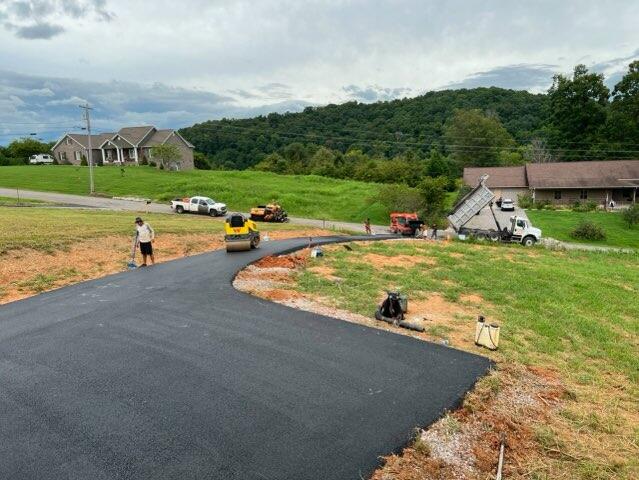 Compactor rolling a new layer of asphalt